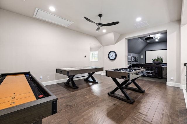 recreation room featuring vaulted ceiling, attic access, dark wood-type flooring, visible vents, and ceiling fan