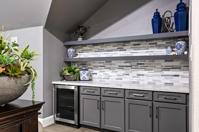 bar with a bar, wine cooler, and backsplash