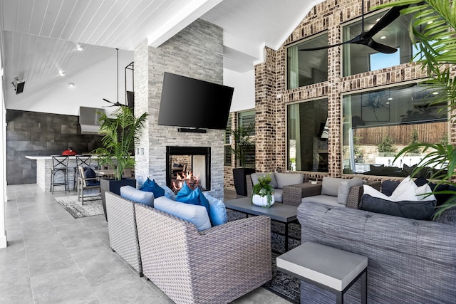 view of patio with an outdoor living space with a fireplace