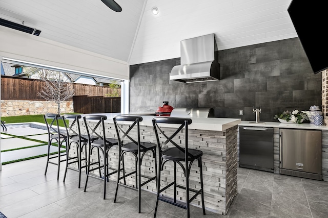 view of patio featuring a sink, fence, outdoor wet bar, and area for grilling