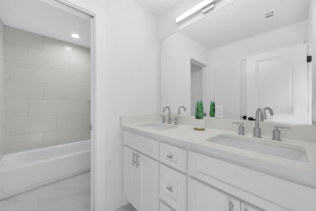 bathroom featuring double vanity, visible vents, marble finish floor, and a sink
