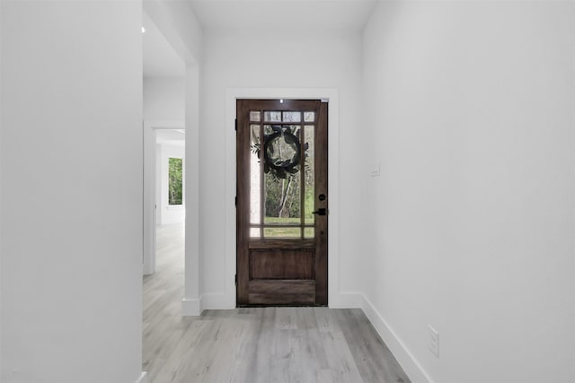 foyer entrance with light wood-type flooring and baseboards