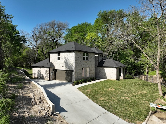 view of home's exterior featuring a yard, fence, brick siding, an attached garage, and driveway