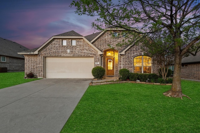 4901 Camp Verde Cir, Sherman, TX 75092 - french country style house with a garage, brick siding, a yard, driveway, and central AC unit