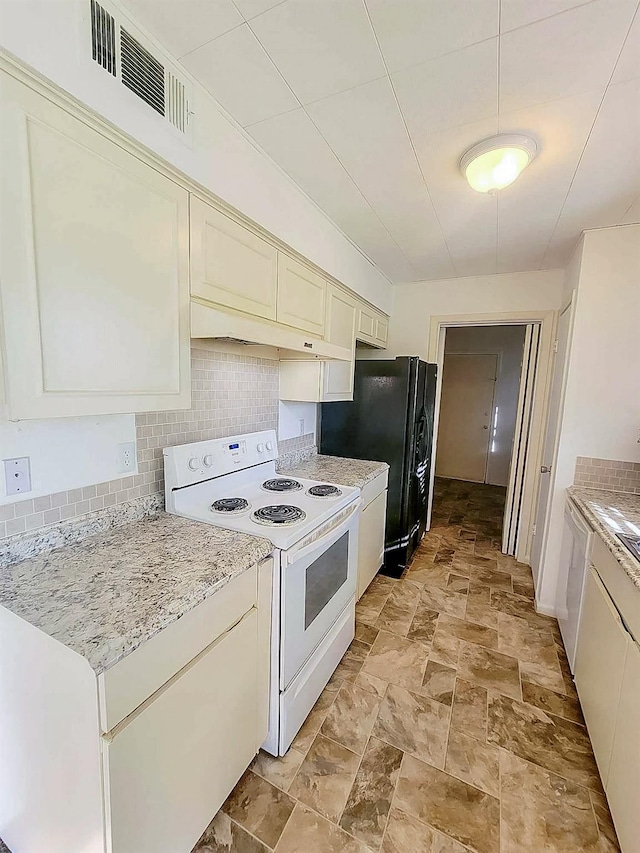 3205 Parkside Dr, Mesquite, TX 75150 - kitchen featuring electric range, light stone finish flooring, tasteful backsplash, freestanding refrigerator, and light stone counters