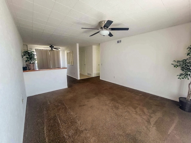 3205 Parkside Dr, Mesquite, TX 75150 - unfurnished living room with ceiling fan, dark carpet, and baseboards