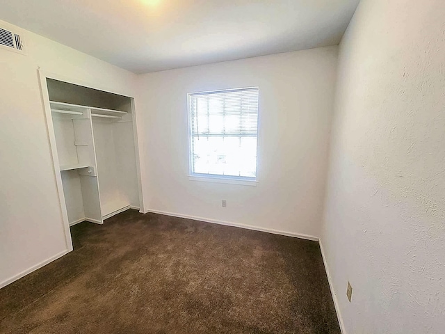 3205 Parkside Dr, Mesquite, TX 75150 - unfurnished bedroom with dark colored carpet, a closet, and baseboards