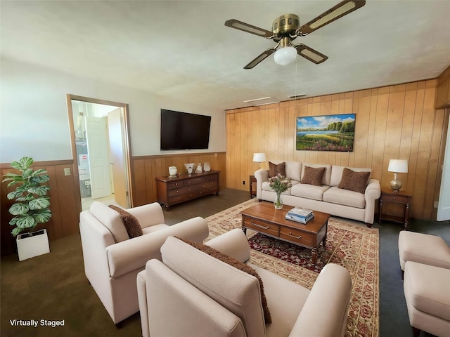 3205 Parkside Dr, Mesquite, TX 75150 - living room with carpet, ceiling fan, wood walls, and a wainscoted wall