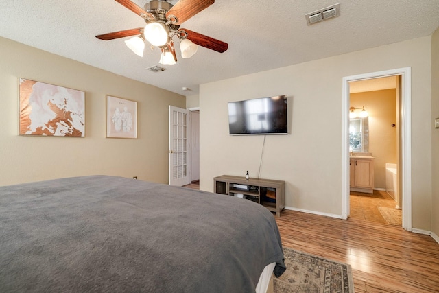 1435 Greenbrook Dr, Rockwall, TX 75032 - bedroom with visible vents, baseboards, a ceiling fan, and wood finished floors