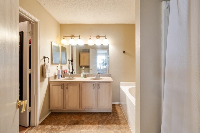 1435 Greenbrook Dr, Rockwall, TX 75032 - full bathroom with a bath, double vanity, a sink, and a textured ceiling