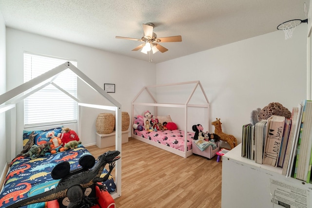 1435 Greenbrook Dr, Rockwall, TX 75032 - bedroom featuring light wood-style flooring, a textured ceiling, and ceiling fan