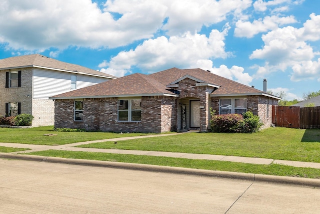 1435 Greenbrook Dr, Rockwall, TX 75032 - view of front of home featuring brick siding, a front yard, and fence