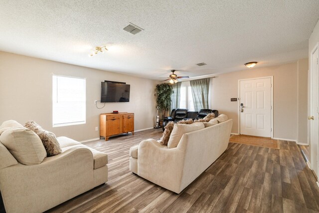 1435 Greenbrook Dr, Rockwall, TX 75032 - living room with ceiling fan, dark wood-type flooring, a textured ceiling, visible vents, and baseboards