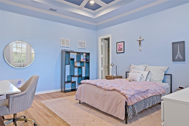 bedroom with light wood-type flooring, baseboards, a high ceiling, visible vents, and coffered ceiling
