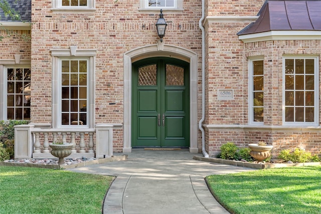 property entrance featuring brick siding