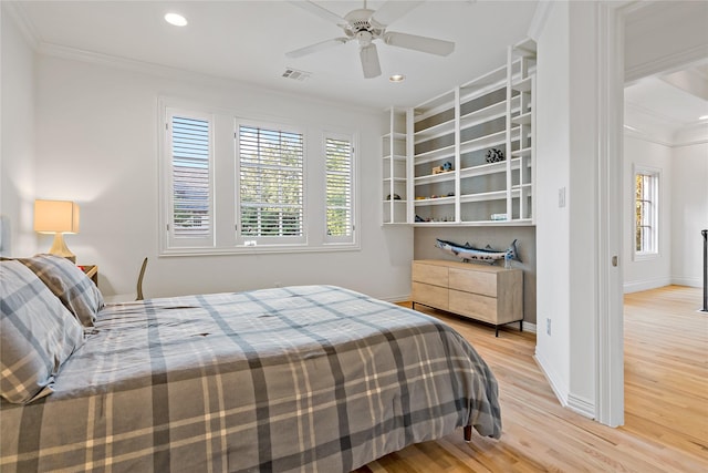 bedroom with baseboards, a ceiling fan, crown molding, recessed lighting, and light wood-style flooring