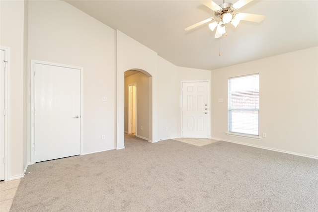 6228 Adonia Dr, Fort Worth, TX 76131 - empty room with baseboards, vaulted ceiling, ceiling fan, arched walkways, and light colored carpet