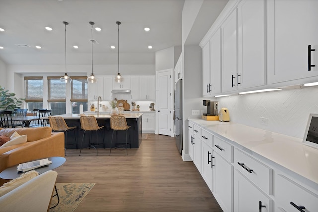 1920 Barnhill Ln, Van Alstyne, TX 75495 - kitchen with white cabinetry, decorative backsplash, freestanding refrigerator, open floor plan, and dark wood-style floors