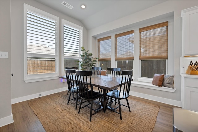 dining space with baseboards, recessed lighting, visible vents, lofted ceiling, and wood finished floors