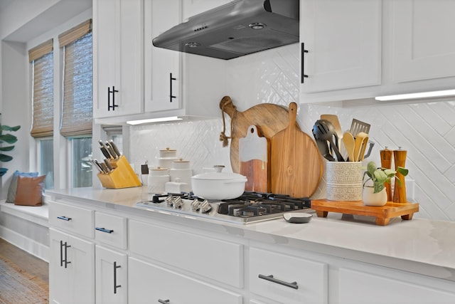 1920 Barnhill Ln, Van Alstyne, TX 75495 - kitchen with under cabinet range hood, stainless steel gas stovetop, backsplash, white cabinetry, and light countertops