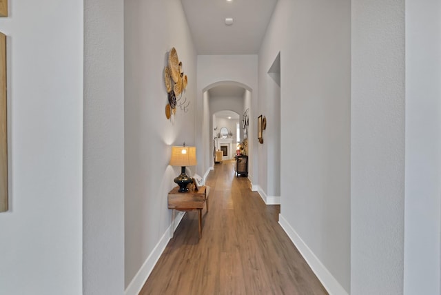 1920 Barnhill Ln, Van Alstyne, TX 75495 - hall with arched walkways, baseboards, and wood finished floors