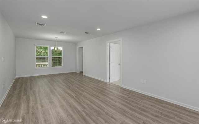 spare room with recessed lighting, visible vents, light wood-type flooring, and baseboards