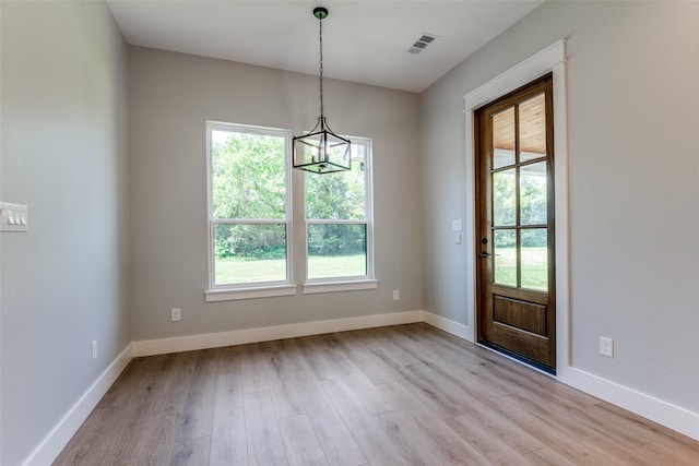 3822 Evergreen Ln, Caddo Mills, TX 75135 - unfurnished dining area with plenty of natural light, light wood-style floors, a chandelier, and baseboards