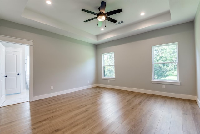 3822 Evergreen Ln, Caddo Mills, TX 75135 - unfurnished room featuring a tray ceiling, ceiling fan, light wood-type flooring, recessed lighting, and baseboards