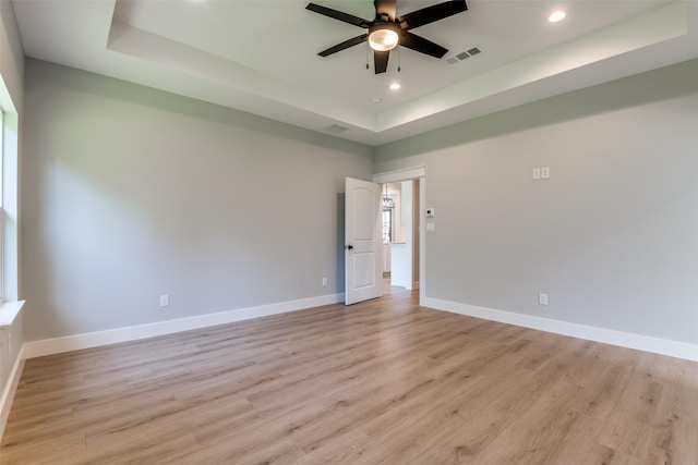 3822 Evergreen Ln, Caddo Mills, TX 75135 - unfurnished room with a tray ceiling, ceiling fan, recessed lighting, light wood-style floors, and baseboards