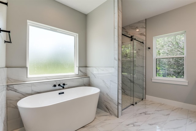 3822 Evergreen Ln, Caddo Mills, TX 75135 - bathroom featuring a freestanding tub, a marble finish shower, marble finish floors, tile walls, and a wainscoted wall