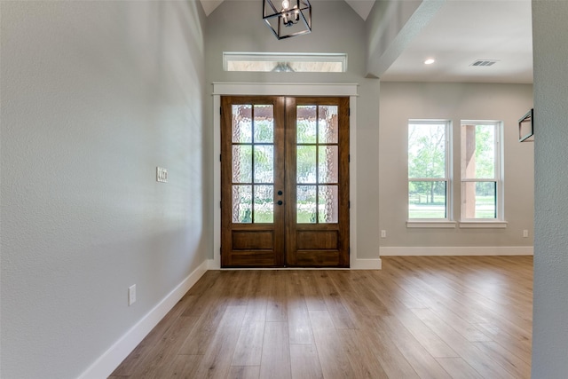 3822 Evergreen Ln, Caddo Mills, TX 75135 - foyer entrance with french doors, wood finished floors, baseboards, a chandelier, and vaulted ceiling