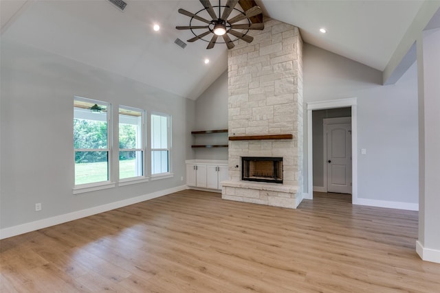 3822 Evergreen Ln, Caddo Mills, TX 75135 - unfurnished living room with a ceiling fan, high vaulted ceiling, a stone fireplace, light wood-style floors, and recessed lighting