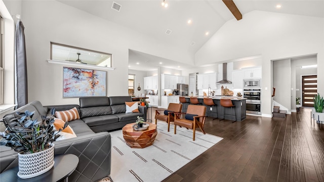 living area with high vaulted ceiling, dark wood-type flooring, beamed ceiling, visible vents, and stairway