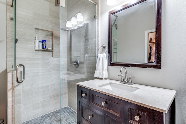 bathroom featuring vanity and a stall shower