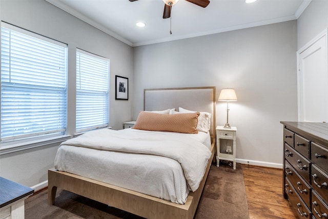 bedroom featuring ornamental molding, baseboards, and multiple windows