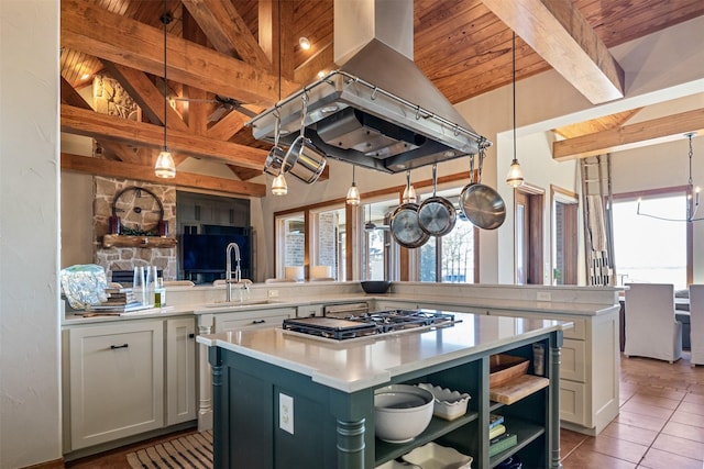kitchen featuring open shelves, a center island, light countertops, a sink, and beam ceiling