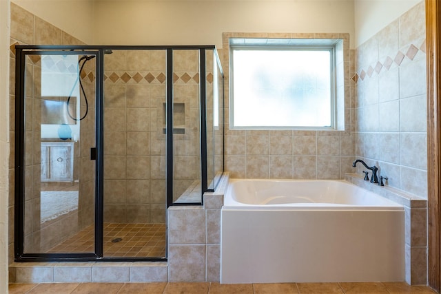 full bathroom with a stall shower, a garden tub, and tile patterned floors