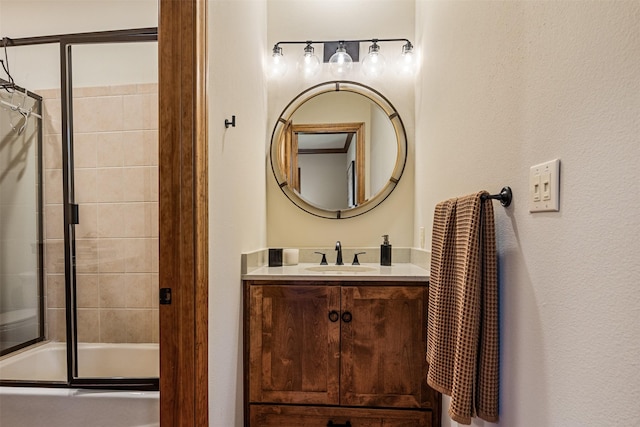 bathroom featuring bath / shower combo with glass door and vanity