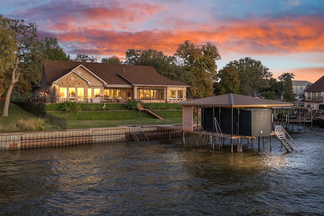 dock area featuring a water view, stairs, and a lawn