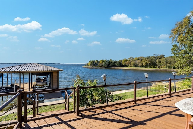 deck featuring boat lift, a boat dock, and a water view