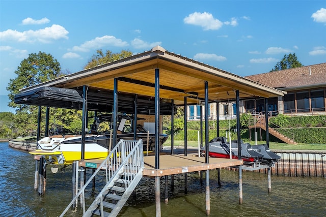 dock area featuring boat lift and a water view