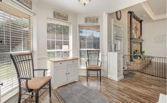 living area featuring ornamental molding and wood finished floors