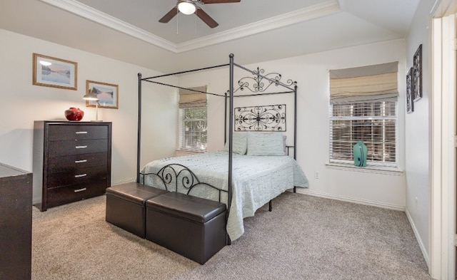 bedroom with carpet, baseboards, ornamental molding, and a raised ceiling