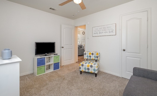 sitting room with visible vents, baseboards, a ceiling fan, and carpet floors