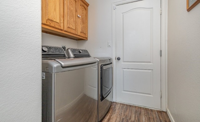 laundry room with washer and dryer, dark wood-style flooring, and cabinet space