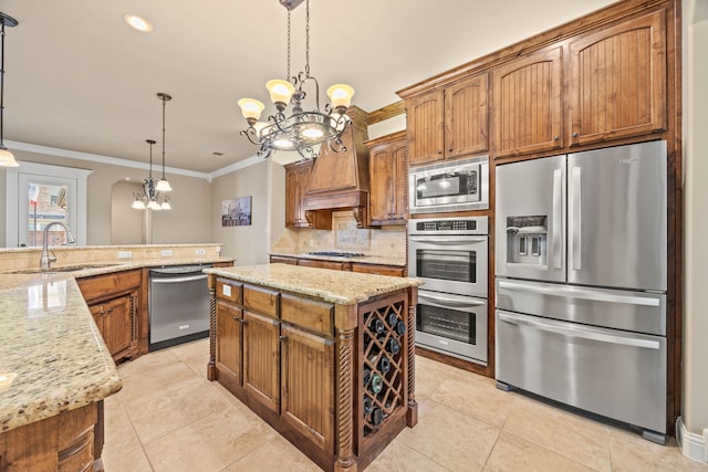 kitchen featuring a notable chandelier, ornamental molding, appliances with stainless steel finishes, and tasteful backsplash