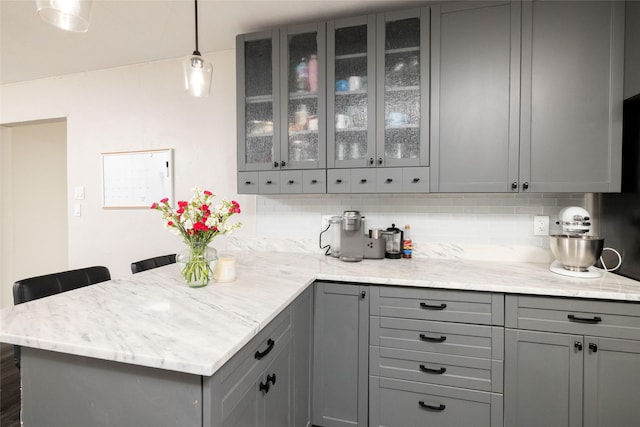 bar with tasteful backsplash and pendant lighting