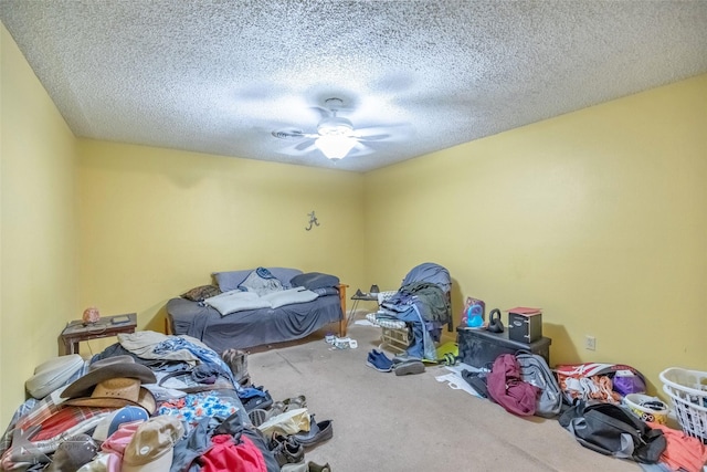 unfurnished bedroom featuring a ceiling fan, carpet, and a textured ceiling