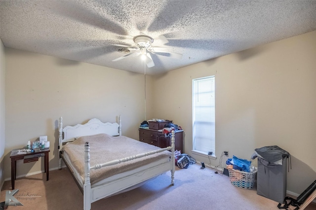 bedroom featuring light colored carpet, baseboards, a ceiling fan, and a textured ceiling