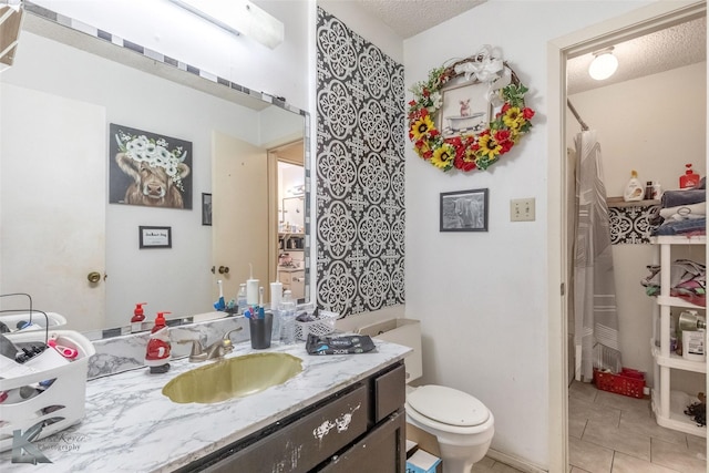 full bath with a textured ceiling, vanity, toilet, tile patterned flooring, and a shower with shower curtain